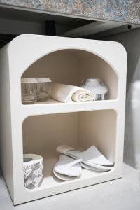 a white shelf with dishes and napkins on it at Guest House Azzurra in Lampedusa
