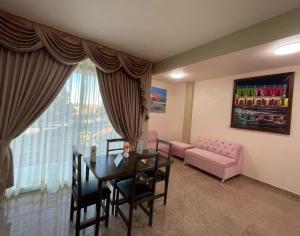 a living room with a dining table and a couch at HOTEL OTOMI in Otumba de Gómez Farías