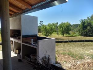 a concrete kitchen with a view of a field at Los Agapantos in Concordia