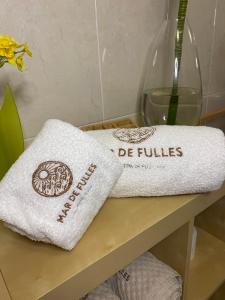 two towels sitting on a table in a bathroom at Mar de Fulles in Buarcos +23 photos