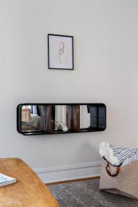 a mirror on the wall in a living room at Flexhome Bucktown 2BR C1 - READ INFO in Chicago