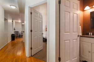 a hallway with a white door and a kitchen at Flexhome Wicker Park 2BR P1 - READ INFO in Chicago