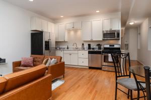 a kitchen and living room with a couch and a table at Flexhome Wicker Park 2BR P1 - READ INFO in Chicago