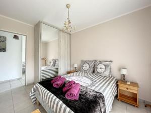een slaapkamer met een bed met roze handdoeken bij Nice family apartment close to the beach in Le Lavandou
