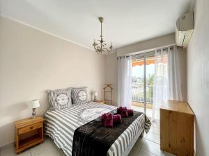 a bedroom with a bed with red bows on it at Nice family apartment close to the beach in Le Lavandou