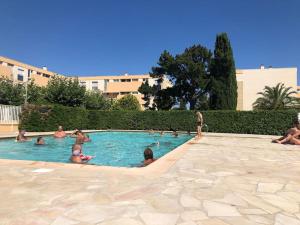a group of people in a swimming pool at Nice family apartment close to the beach in Le Lavandou