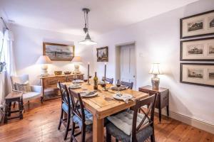 a dining room with a wooden table and chairs at Mole Cottage, Orford in Woodbridge