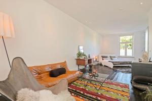 a living room with a couch and a table at Bohemian Residence in Maastricht