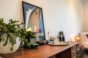 a wooden table with a vase and glasses on it at Bohemian Residence in Maastricht