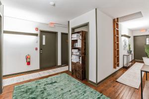 un pasillo con dos puertas y una alfombra verde en Charming Studio in Thornton PA, 