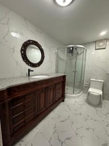 a bathroom with a sink and a shower and a mirror at Lawson’s Beach Resort in San Juan