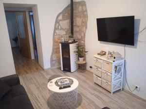 a living room with a flat screen tv on a wall at Apartman Iva in Pula