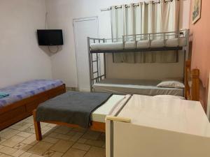 Ένα ή περισσότερα κρεβάτια σε δωμάτιο στο Pousada terraco Rio Centro +1 φωτογραφίες