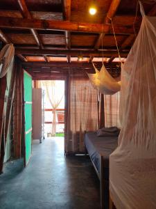 a room with a bed and a hammock in it at Wally's House Mancora in Máncora