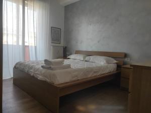 a bedroom with a bed with towels on it at Appartamento - Rho Centro 6 - in Rho +6 photos