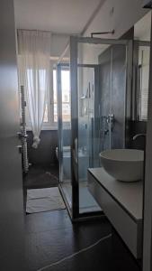 a bathroom with a sink and a glass shower at Appartamento - Rho Centro 6 - in Rho