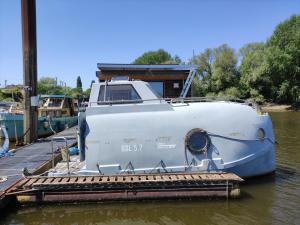 a boat is docked at a dock in the water at Ausgebautes Rettungsboot GORCH POTT in Hamburg