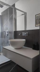a bathroom with a bowl sink and a shower at Appartamento - Rho Centro 6 - in Rho