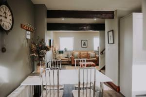 a kitchen and living room with a table and chairs at Pattys Barn Holiday Cottages, Cabins and Venue Hire in Cockerham