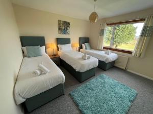 a bedroom with two beds and a window at Chesters in Kingholm Quay