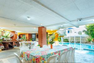 a dining room with a table and chairs and a pool at RedDoorz @ Yahweh Spring Retreat & Resort Laguna in Calamba