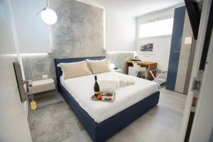 a bedroom with a bed with a tray of food on it at Guest House Azzurra in Lampedusa