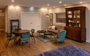 a living room with a table and chairs and a couch at Casal da Viúva in Armamar