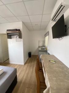 a room with two beds and a kitchen with a sink at Complejo 599 in San Luis