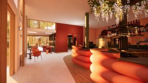 een restaurant met rode muren en een bar met rode stoelen bij Fletcher Hotel Restaurant De Mallejan in Vierhouten