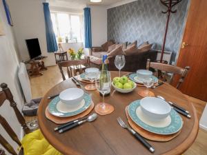 a dining room table with plates and wine glasses at Flat 2, Clifton Gardens in Southampton