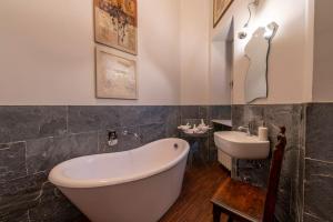 a bathroom with a white tub and a sink at [Centro] Splendido Appartamento di Design in Turin