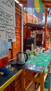a table with plates and bowls on it with a tea kettle at Wally's House Mancora in Máncora