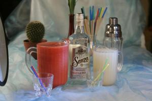 a table with a bottle of spirits and glasses at TOUCH DOWN Motel in Lohmar +49 photos