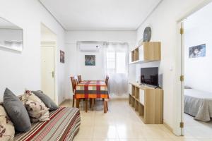 a living room with a couch and a table at Zona Garbí in Valencia