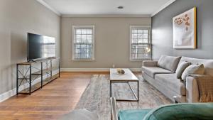 uma sala de estar com um sofá e uma televisão de ecrã plano em Landing Modern Apartment with Amazing Amenities (ID2690X00) em Nashville