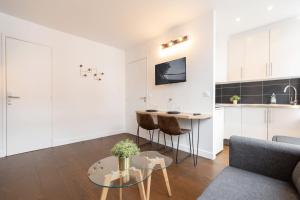 a living room with a couch and a table at Lille Gares - Nice equipped apartment in Lille