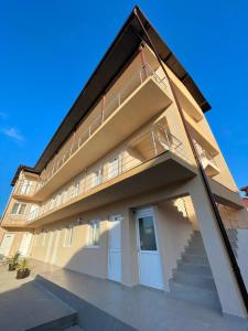 a large building with a staircase in front of it at Vila Cochilia Costinesti ULTRACENTRAL 3 stele in Costinesti