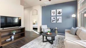 a living room with a couch and a tv at Landing Modern Apartment with Amazing Amenities (ID8267X35) in Tucson