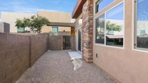 a brick wall next to a building with a window at Landing Modern Apartment with Amazing Amenities (ID8267X35) in Tucson