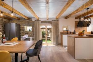 a kitchen and dining room with a wooden table and chairs at Villa Palazza in Pazin