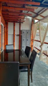 a dining room with a wooden table and chairs at Wally's House Mancora in Máncora