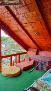 a balcony with a table and chairs on a deck at Wally's House Mancora in Máncora