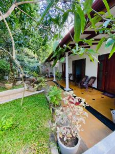 a patio of a house with a bunch of plants at Richwin Villa Dambulla in Dambulla