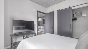 a bedroom with a bed and a flat screen tv at Landing Modern Apartment with Amazing Amenities (ID4859X97) in Chicago