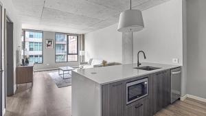 a kitchen with a sink and a counter top at Landing Modern Apartment with Amazing Amenities (ID4859X97) in Chicago
