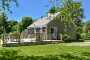 a small house with a porch and a deck at Huge Deck Outdoor Shower Dog Friendly in Brewster