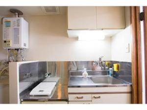 a small kitchen with a sink and a microwave at Haimu Shanzerize 7,12 - Vacation STAY 11296 in Sapporo
