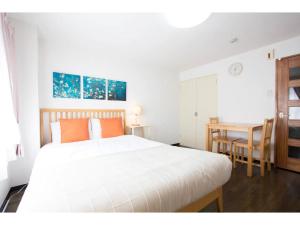 a bedroom with a large white bed and a table at Haimu Shanzerize 7,12 - Vacation STAY 11296 in Sapporo