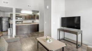a living room with a large flat screen tv at Landing Modern Apartment with Amazing Amenities (ID2951X44) in West Valley City