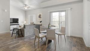 a dining room and living room with a table and chairs at Landing Modern Apartment with Amazing Amenities (ID2951X44) in West Valley City